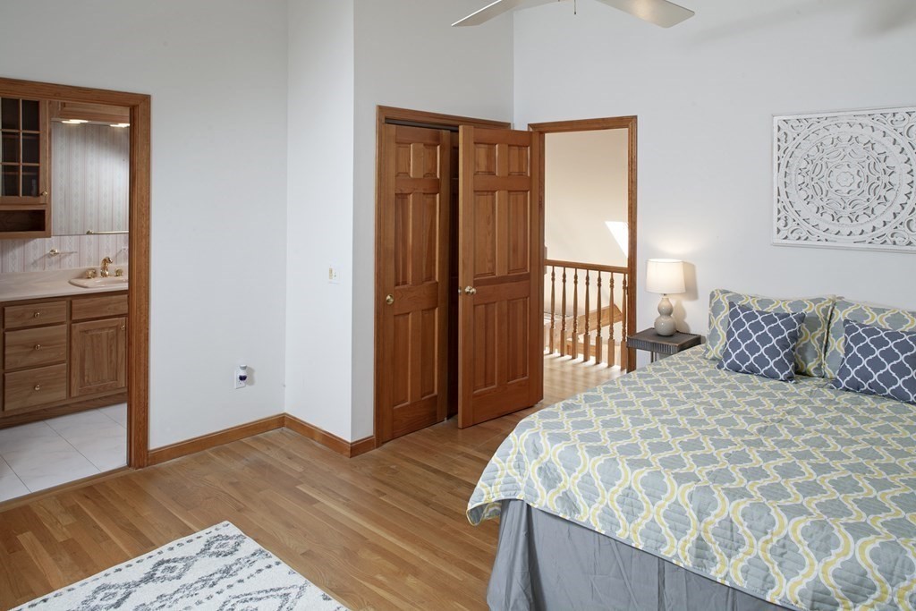 93 Beach Road Orleans, MA 02653 - Photo 21 of 28 a bedroom with a large bed and wooden floor