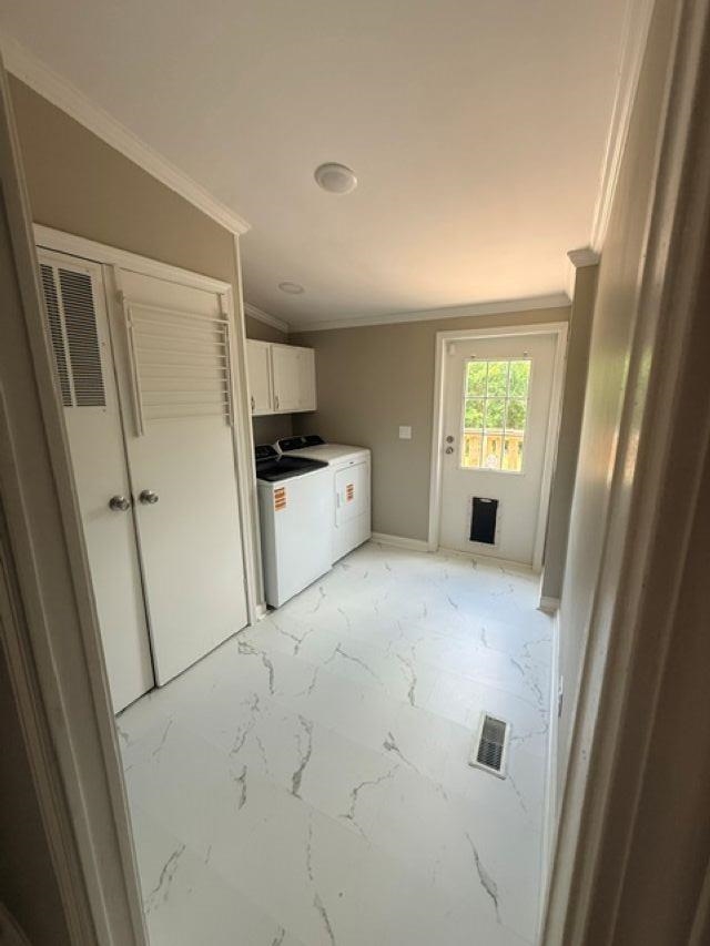 229 Coats Road Brighton, TN 38011 - Photo 14 of 14 Laundry area featuring white cabinetry, white-finish flooring with gray veining, a white door with a pet door insert, crown molding