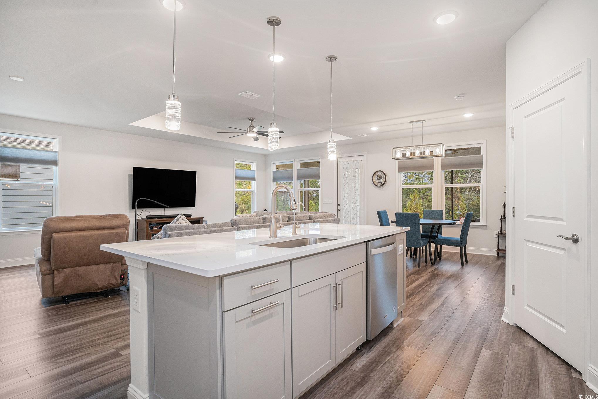 1609 Littleleaf Loop North Myrtle Beach, SC 29582 - Photo 11 of 40 Kitchen with recessed lighting, plenty of natural light, dark wood-style flooring, hanging light fixtures, and light stone counters