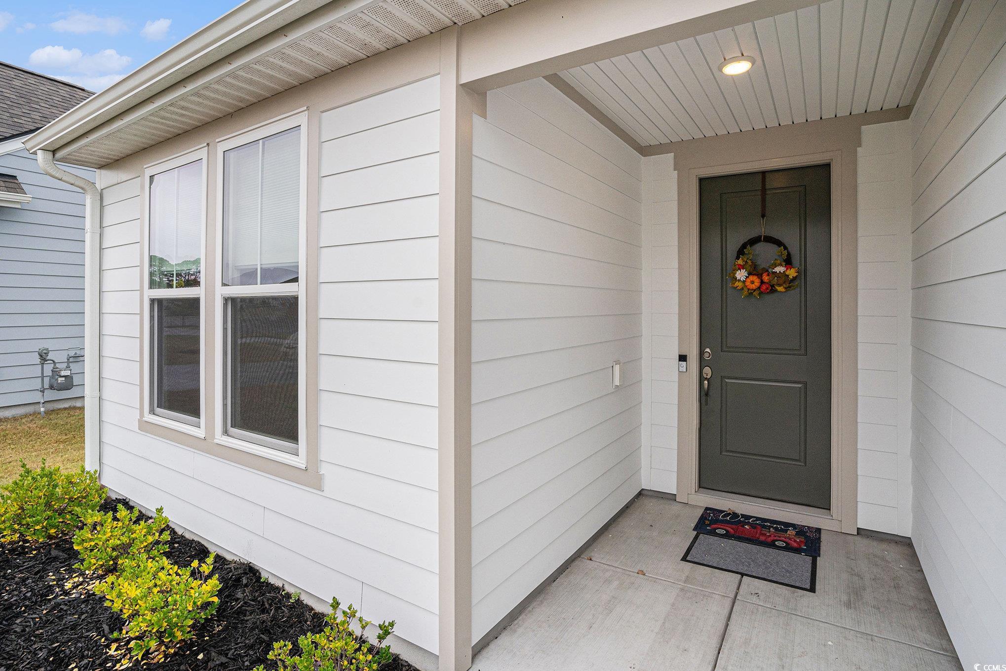 1609 Littleleaf Loop North Myrtle Beach, SC 29582 - Photo 2 of 40 Doorway to property with roof with shingles
