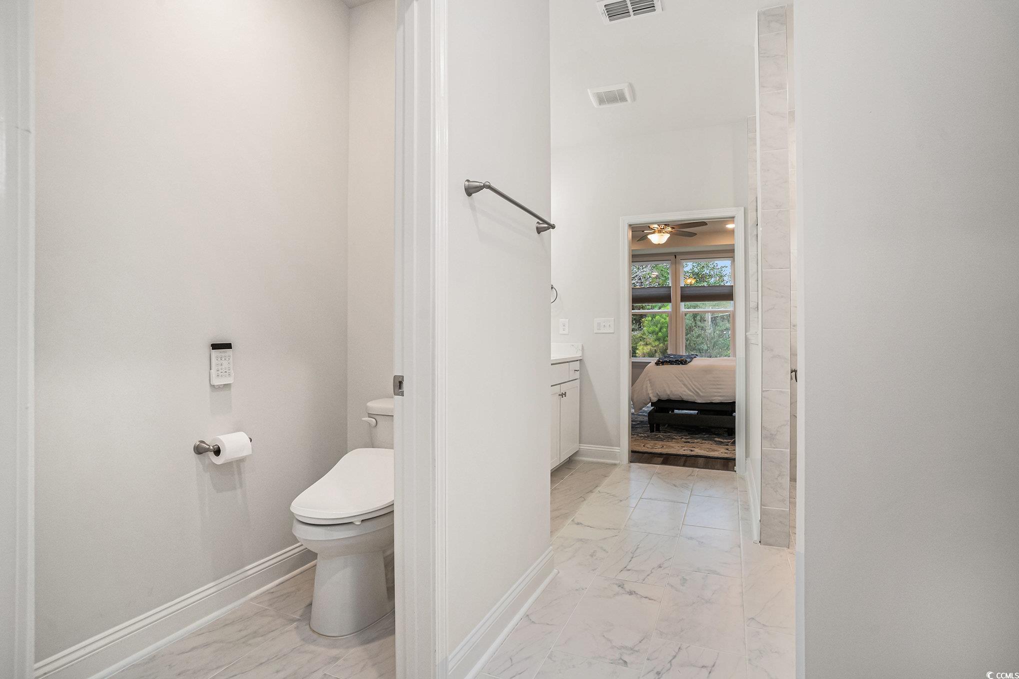 1609 Littleleaf Loop North Myrtle Beach, SC 29582 - Photo 21 of 40 Ensuite bathroom featuring light marble finish floors and ceiling fan