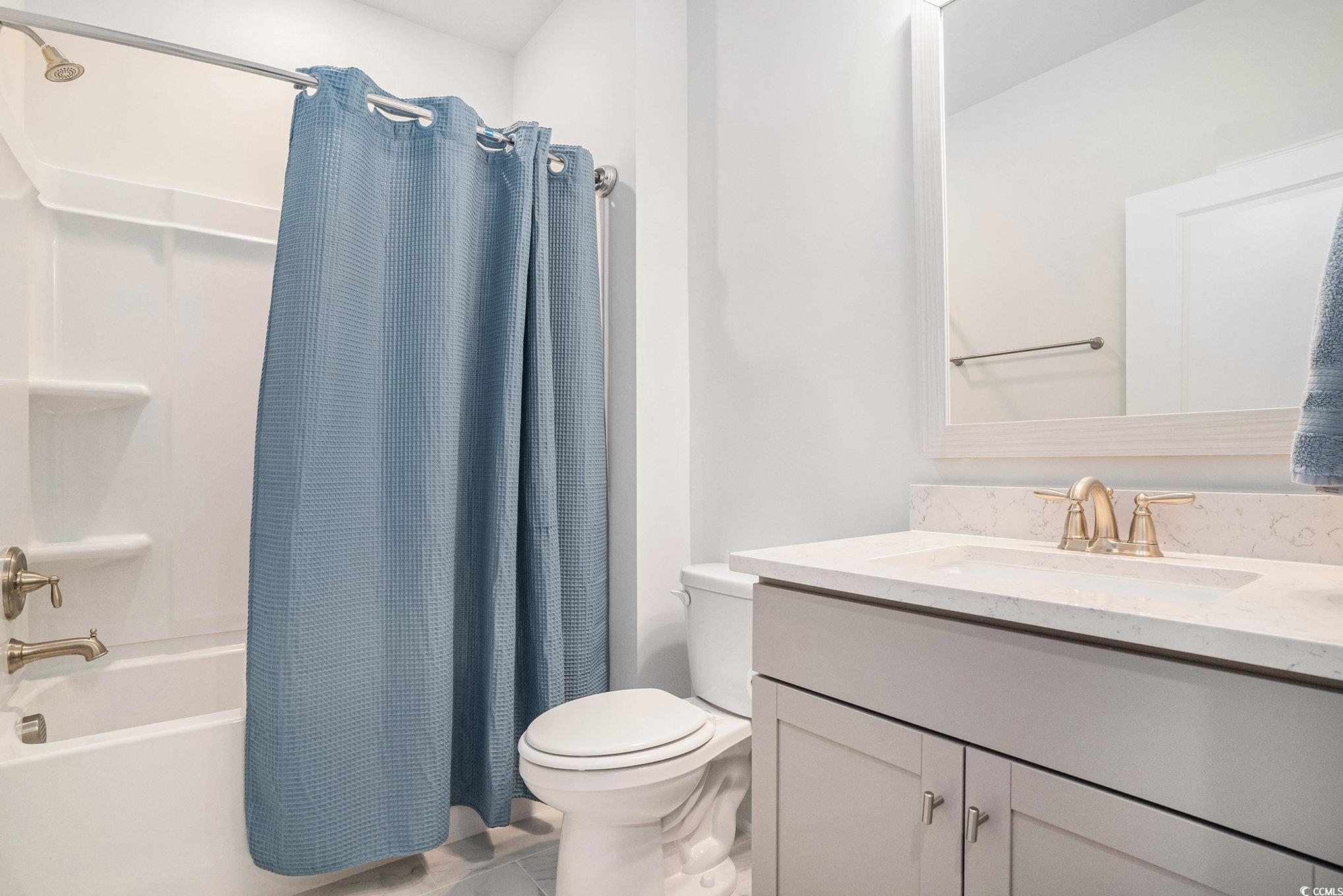 1609 Littleleaf Loop North Myrtle Beach, SC 29582 - Photo 25 of 40 Bathroom with shower / bathtub combination with curtain, vanity, and light tile patterned flooring