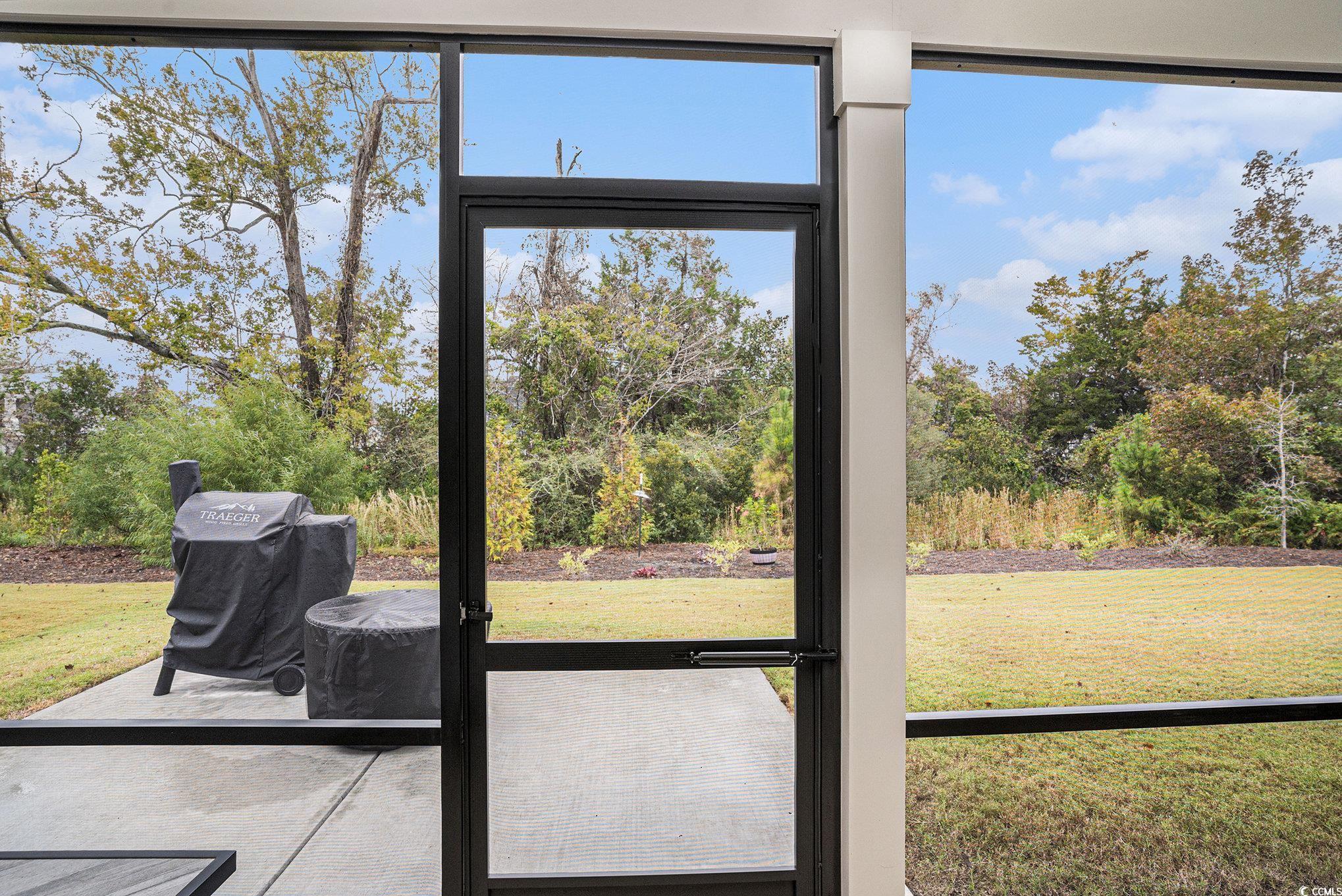 1609 Littleleaf Loop North Myrtle Beach, SC 29582 - Photo 31 of 40 Doorway with view of wooded area and plenty of natural light
