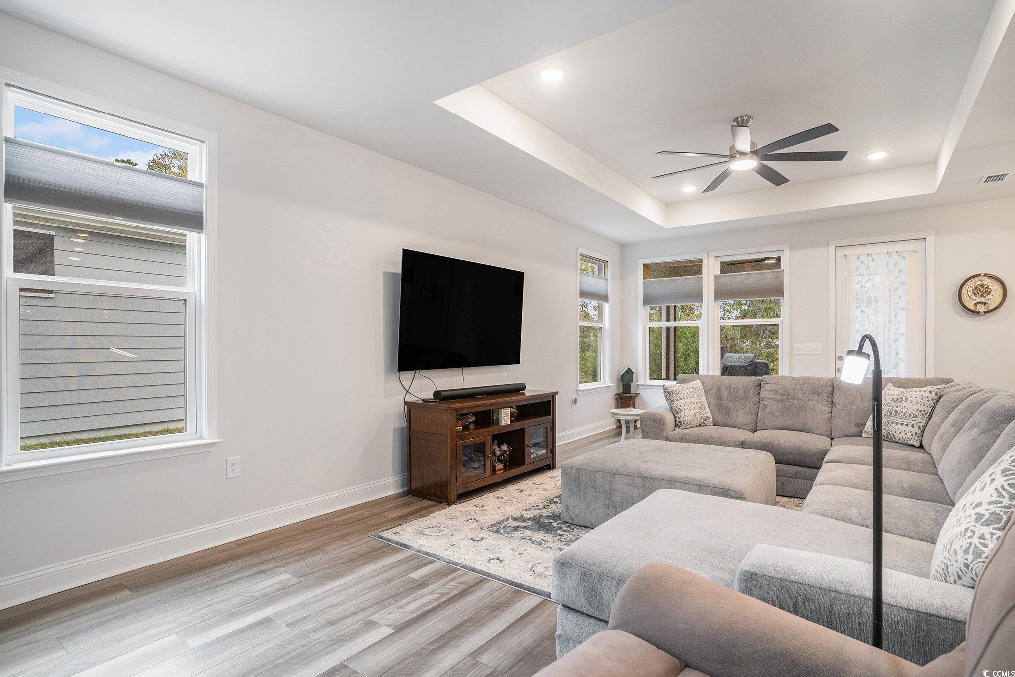 1609 Littleleaf Loop North Myrtle Beach, SC 29582 - Photo 5 of 40 Living area with a raised ceiling, light wood-style floors, recessed lighting, and ceiling fan