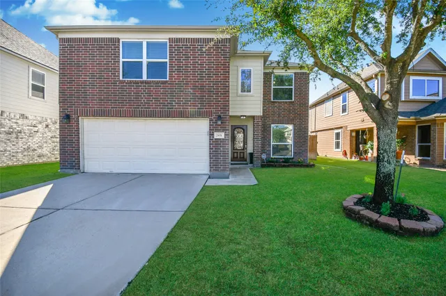 a front view of a house with a garden and plants