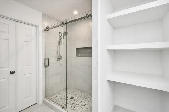 a bathroom with a glass shower door