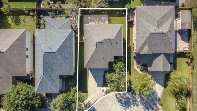 an aerial view of a house with swimming pool and outdoor seating