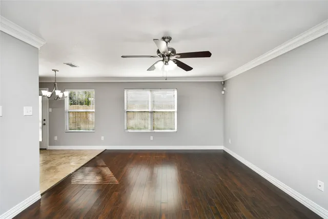 wooden floor in an empty room with a window