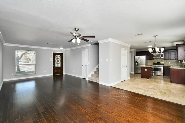 a view of a kitchen with furniture and wooden floor
