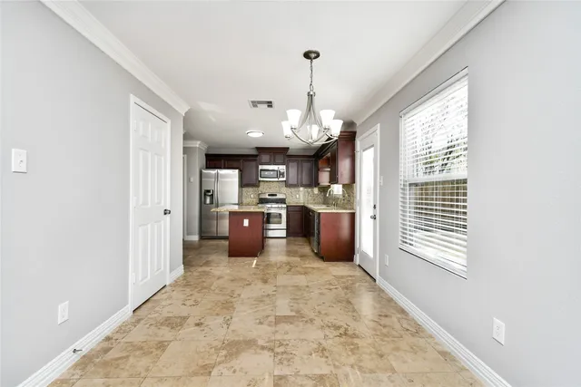 a large white kitchen with a large window