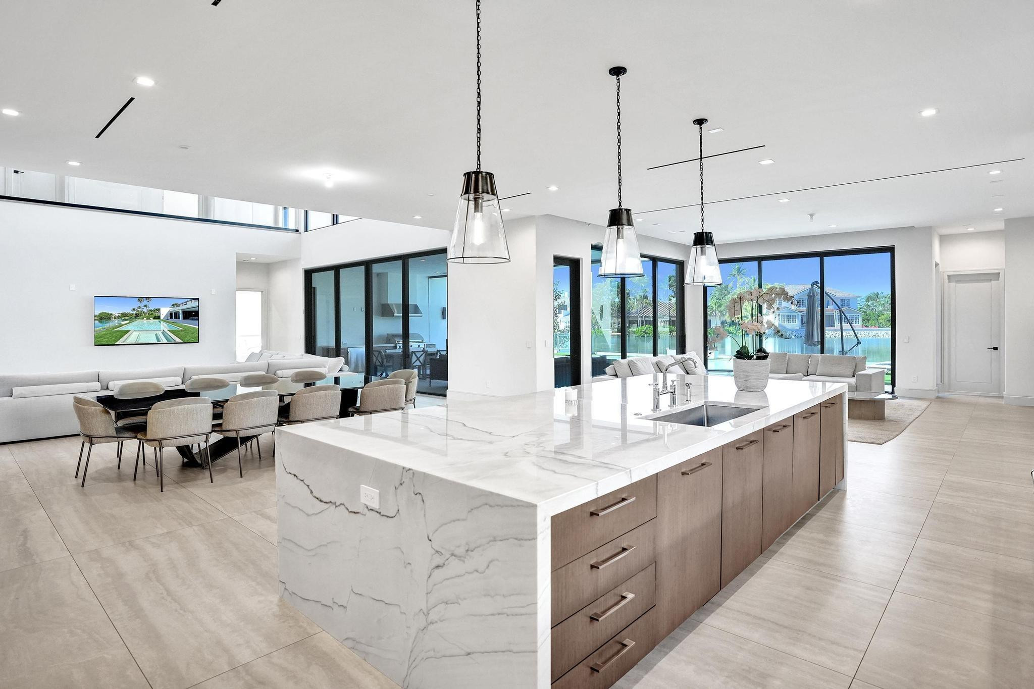 7 Seneca Road Sea Ranch Lakes, FL 33308 - Photo 14 of 65 a large kitchen with kitchen island a large island in it