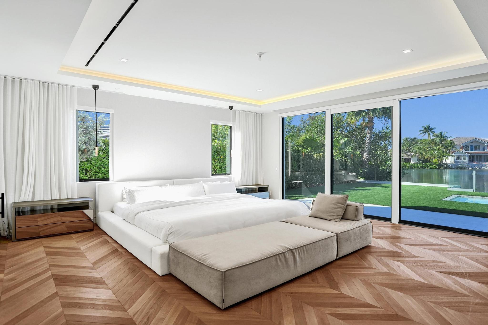 7 Seneca Road Sea Ranch Lakes, FL 33308 - Photo 20 of 65 a bedroom with a bed and large windows