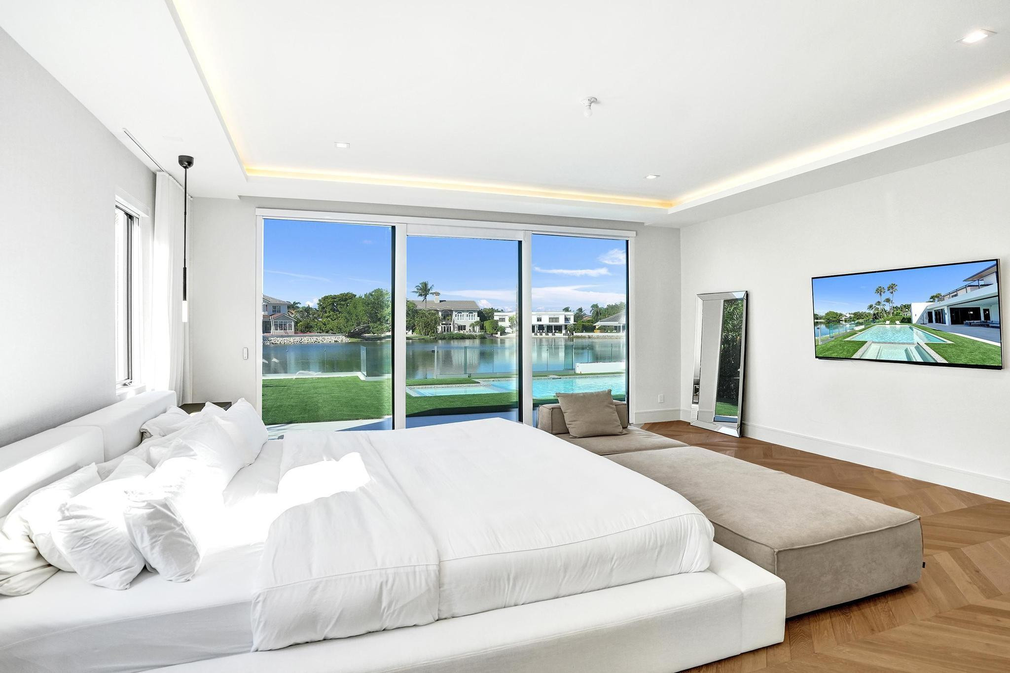 7 Seneca Road Sea Ranch Lakes, FL 33308 - Photo 21 of 65 a bed sitting in a bedroom next to a large window