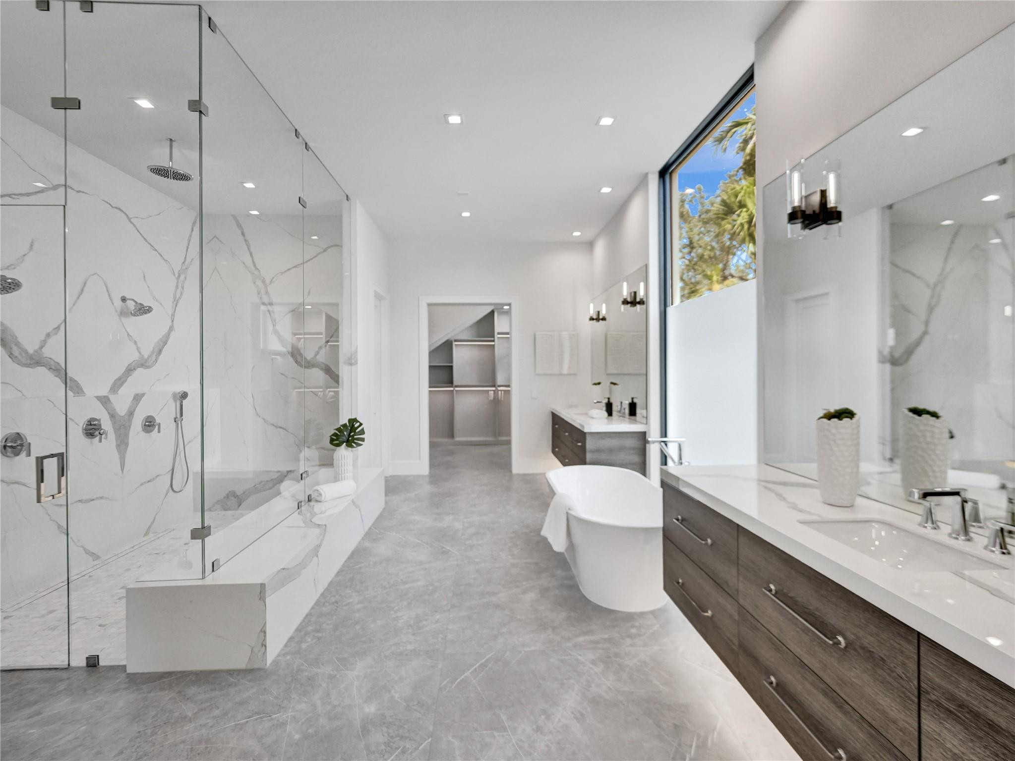 7 Seneca Road Sea Ranch Lakes, FL 33308 - Photo 23 of 65 a large bathroom with a double vanity sink a large mirror and shower