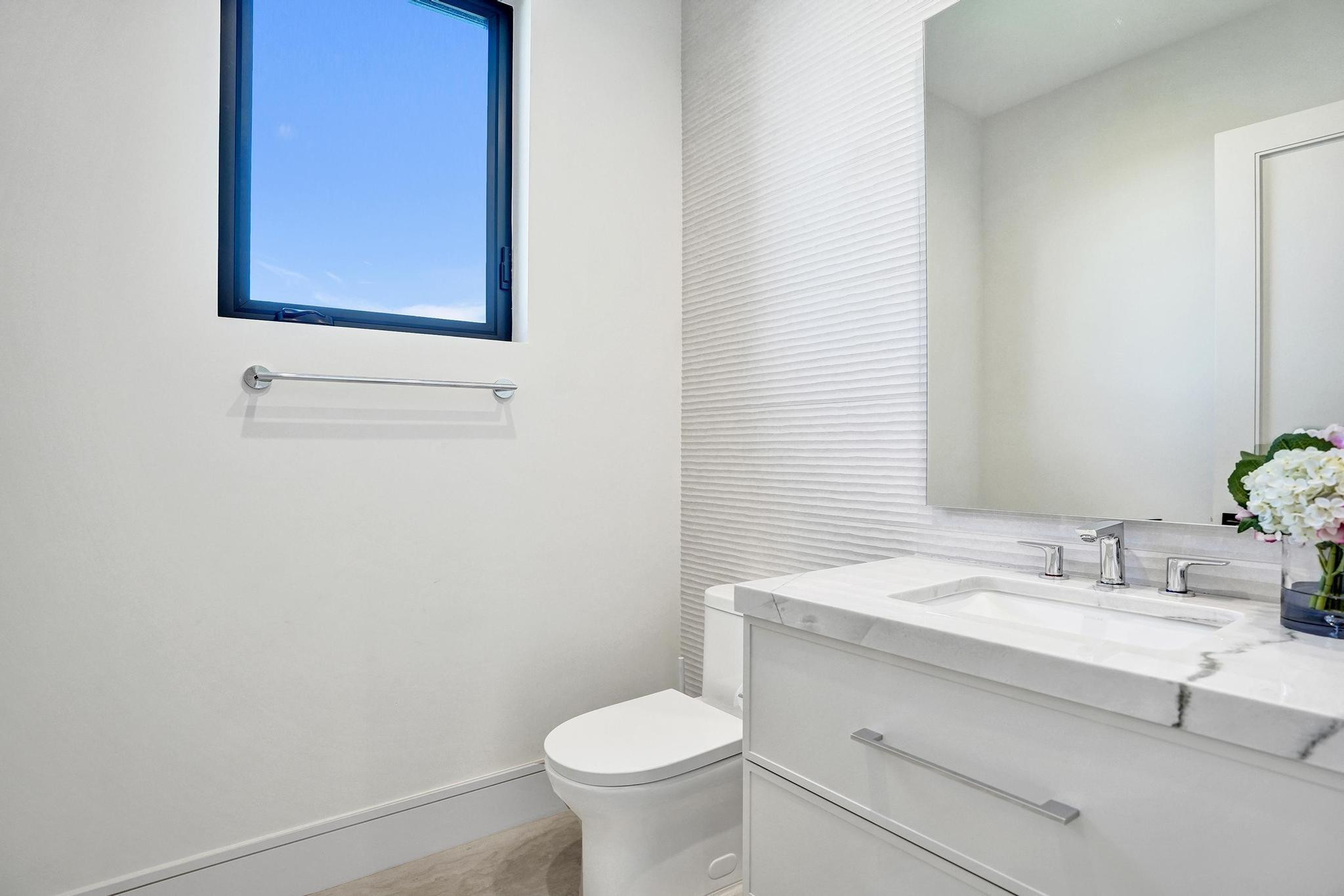 7 Seneca Road Sea Ranch Lakes, FL 33308 - Photo 30 of 65 a bathroom with a sink toilet and mirror
