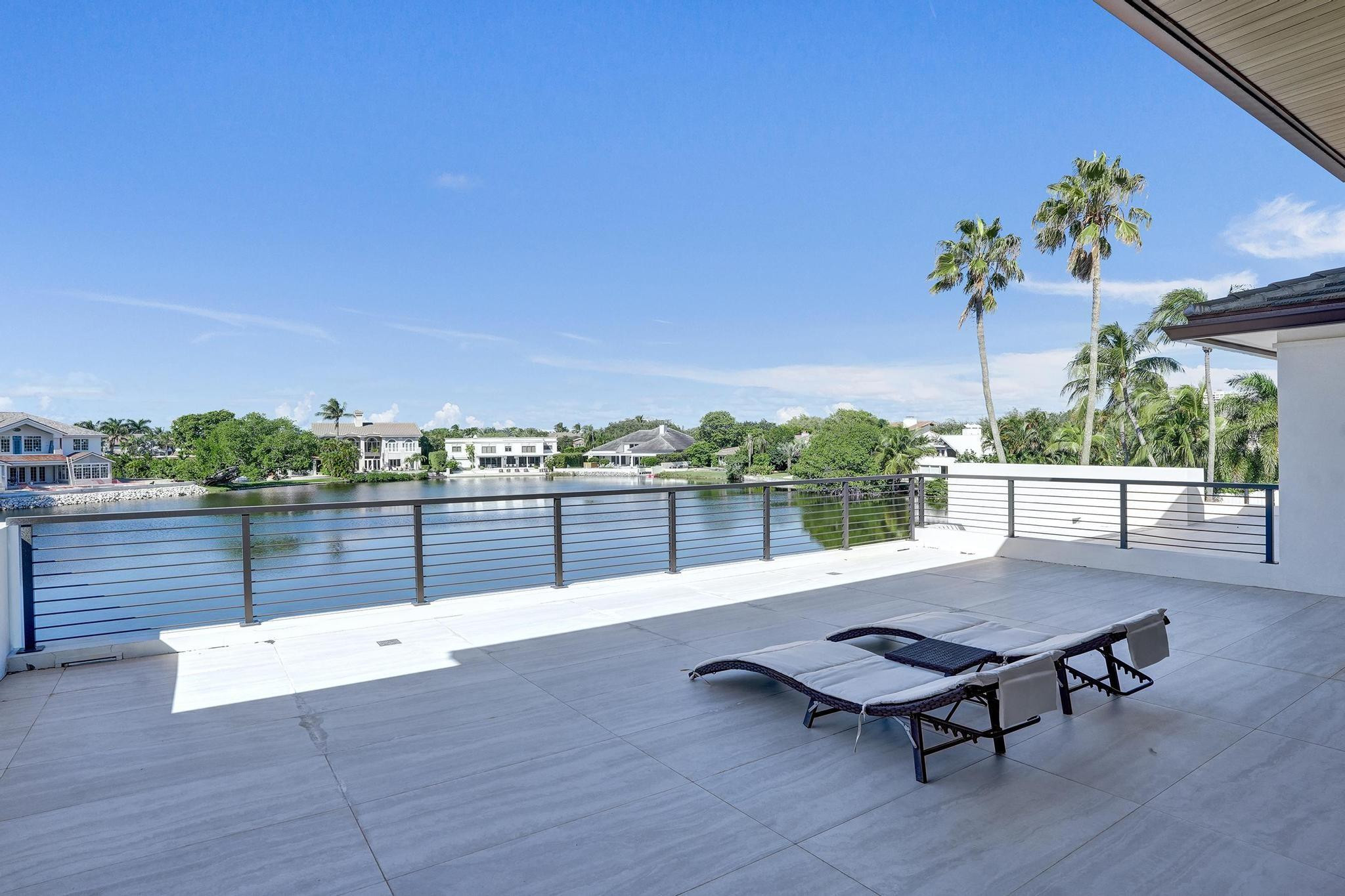 7 Seneca Road Sea Ranch Lakes, FL 33308 - Photo 38 of 65 a view of a terrace with wooden floor and bench