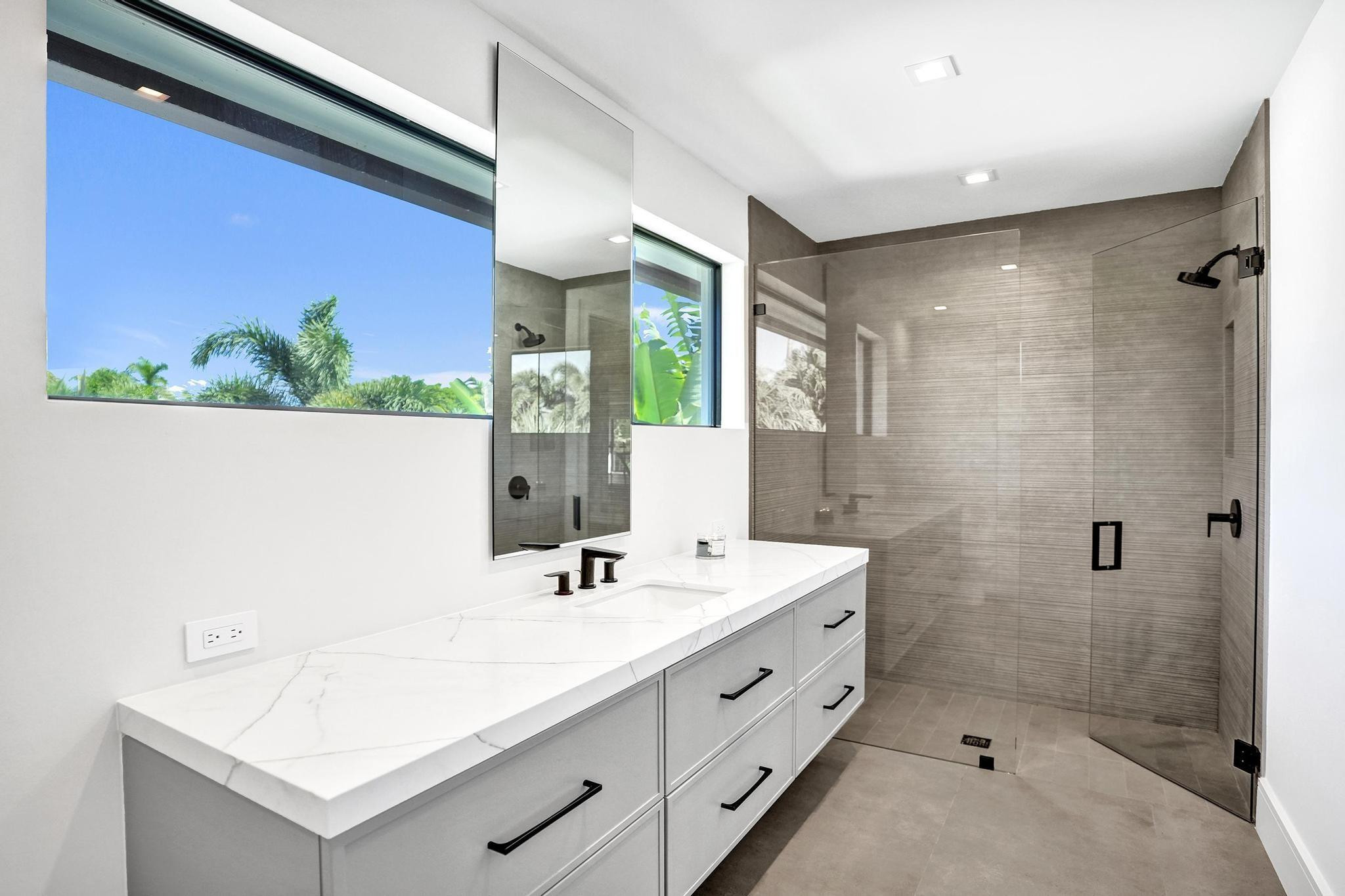 7 Seneca Road Sea Ranch Lakes, FL 33308 - Photo 40 of 65 a bathroom with a double vanity sink mirror and shower