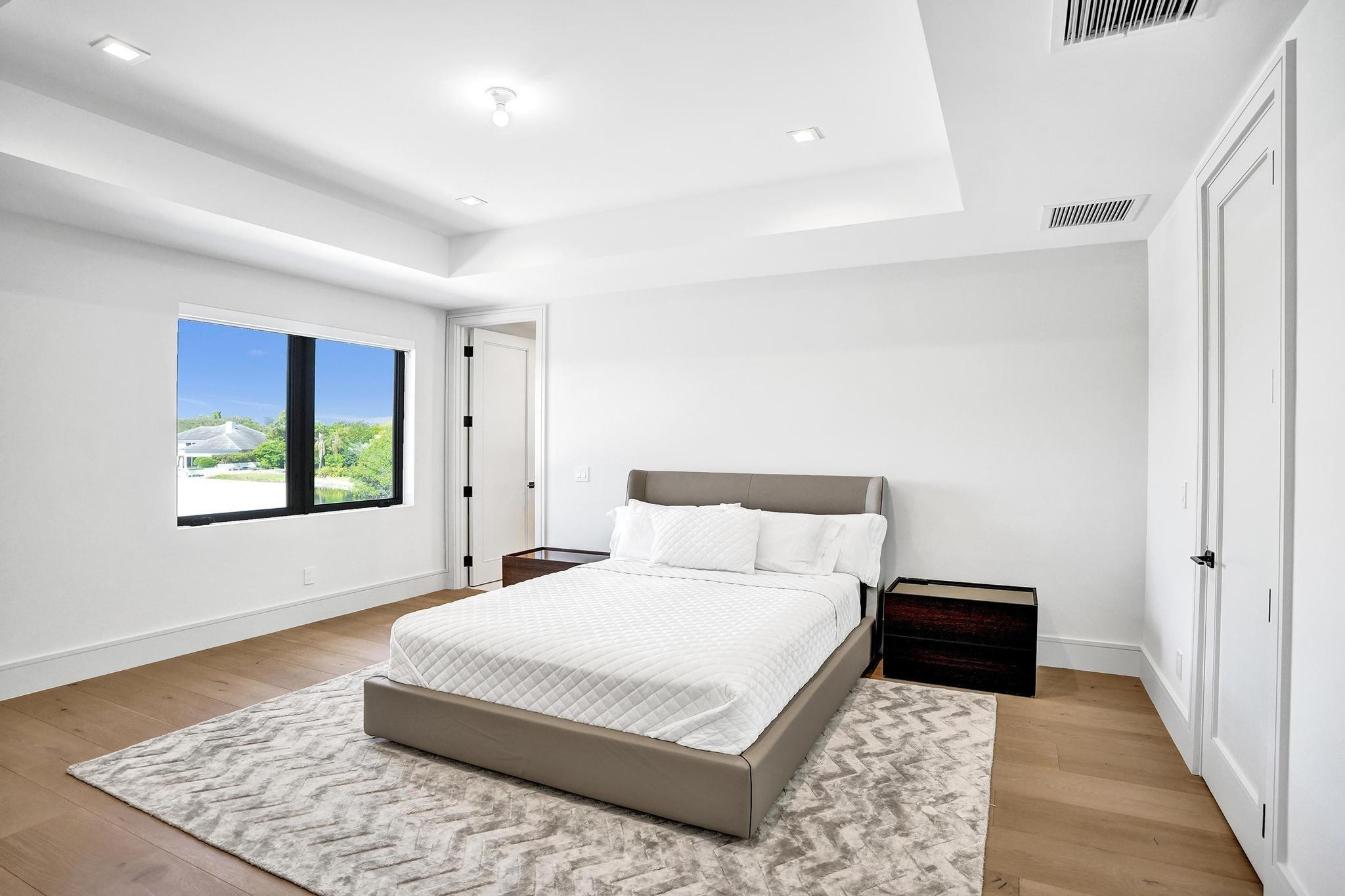 7 Seneca Road Sea Ranch Lakes, FL 33308 - Photo 41 of 65 a bedroom with a large bed and a window