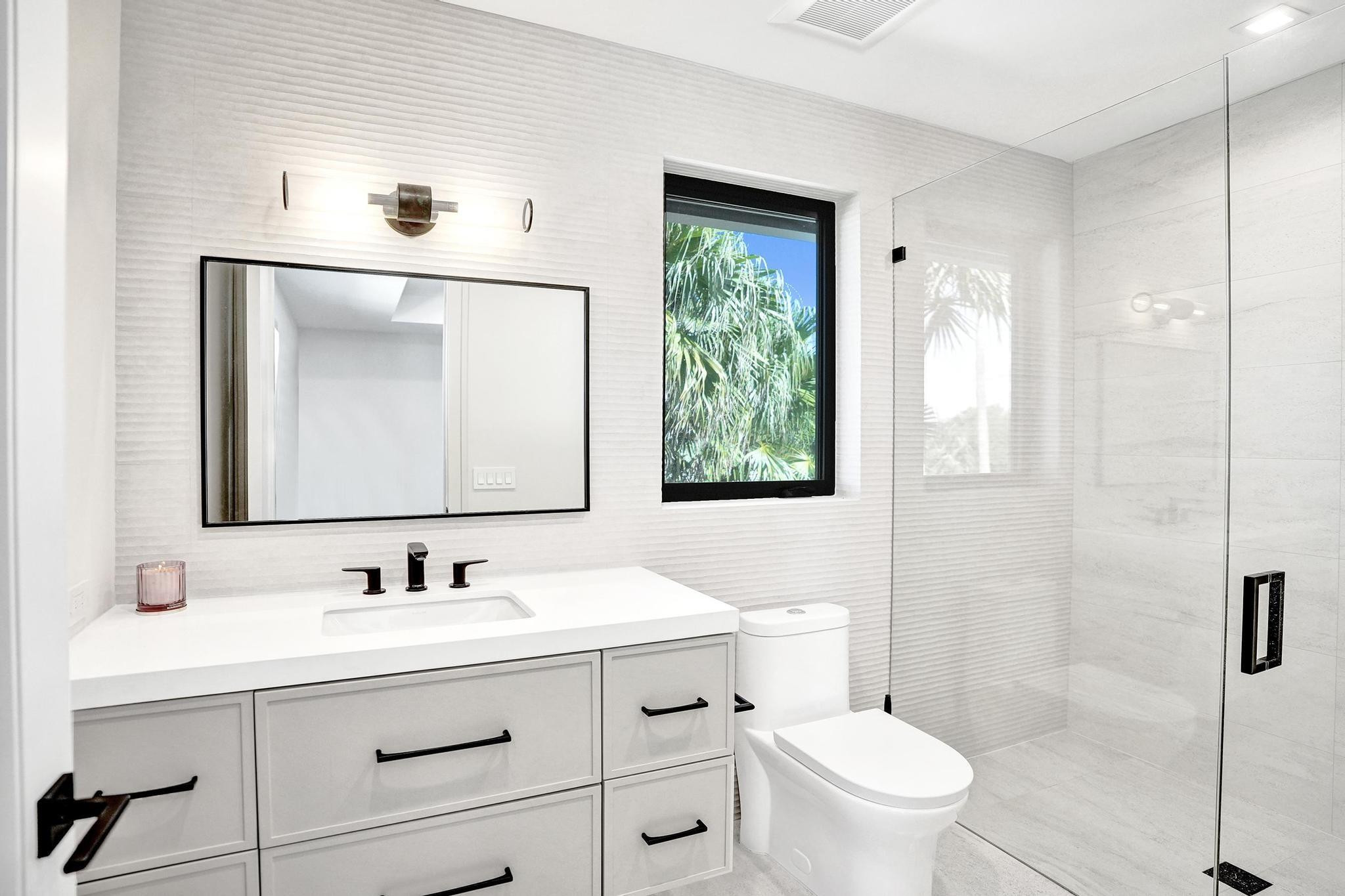 7 Seneca Road Sea Ranch Lakes, FL 33308 - Photo 42 of 65 a bathroom with a sink vanity mirror and toilet