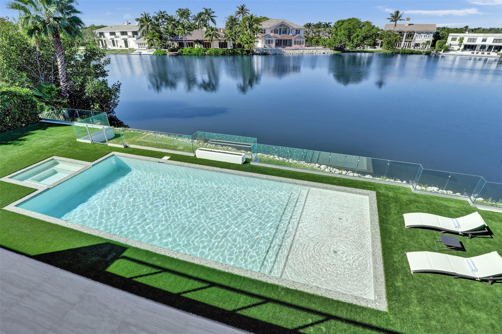 7 Seneca Road Sea Ranch Lakes, FL 33308 - Photo 48 of 65 a view of a swimming pool with a lake view