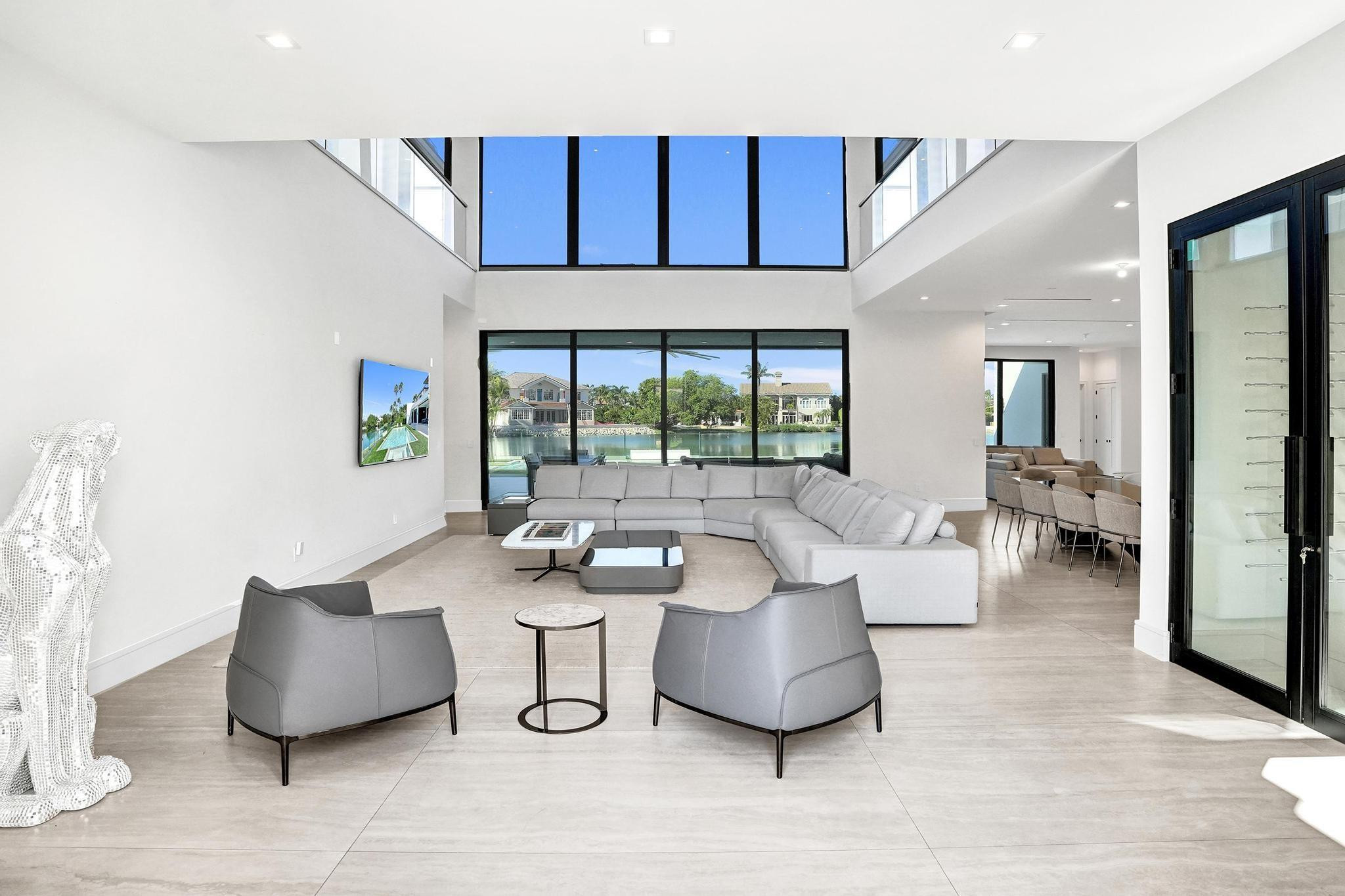 7 Seneca Road Sea Ranch Lakes, FL 33308 - Photo 7 of 65 a living room with furniture and a large window