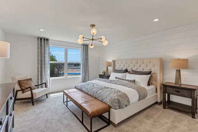 a spacious bedroom with a bed and a window