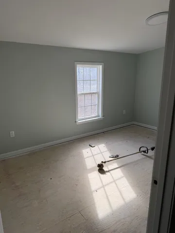 a room with a bed and a window