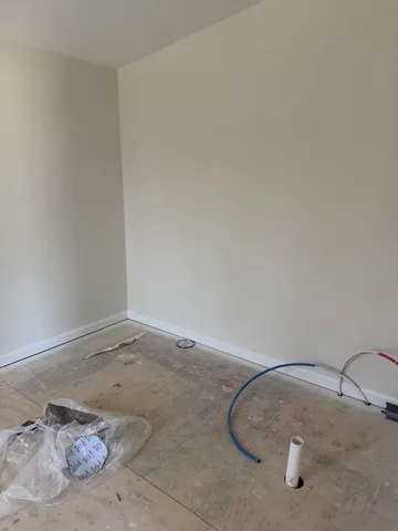 a room with a wooden floor and cabinets