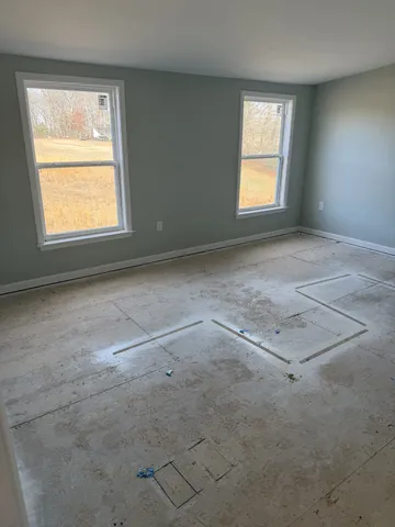 a bedroom with a bed and ceiling fan