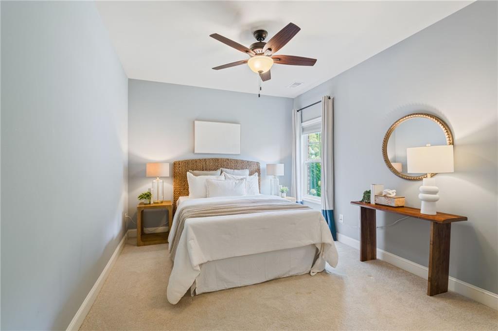 4735 Amble Trace Cumming, GA 30040 - Photo 11 of 73 a bedroom with a bed a chandelier with a large window and a chandelier