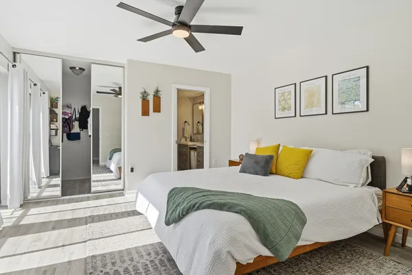 a bedroom with a bed and a chandelier