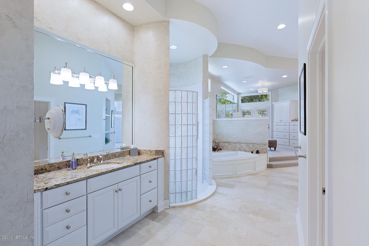 116 Governors Road Ponte Vedra Beach, FL 32082 - Photo 17 of 57 a spacious bathroom with a granite countertop sink a mirror a bathtub and shower