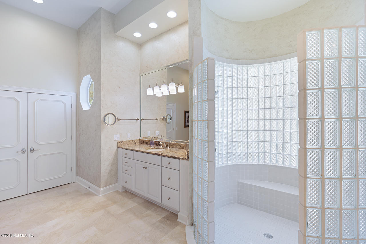 116 Governors Road Ponte Vedra Beach, FL 32082 - Photo 18 of 57 a bathroom with a granite countertop sink a toilet and shower