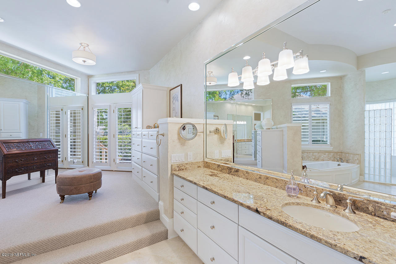 116 Governors Road Ponte Vedra Beach, FL 32082 - Photo 19 of 57 a spacious bathroom with a granite countertop sink and a large mirror