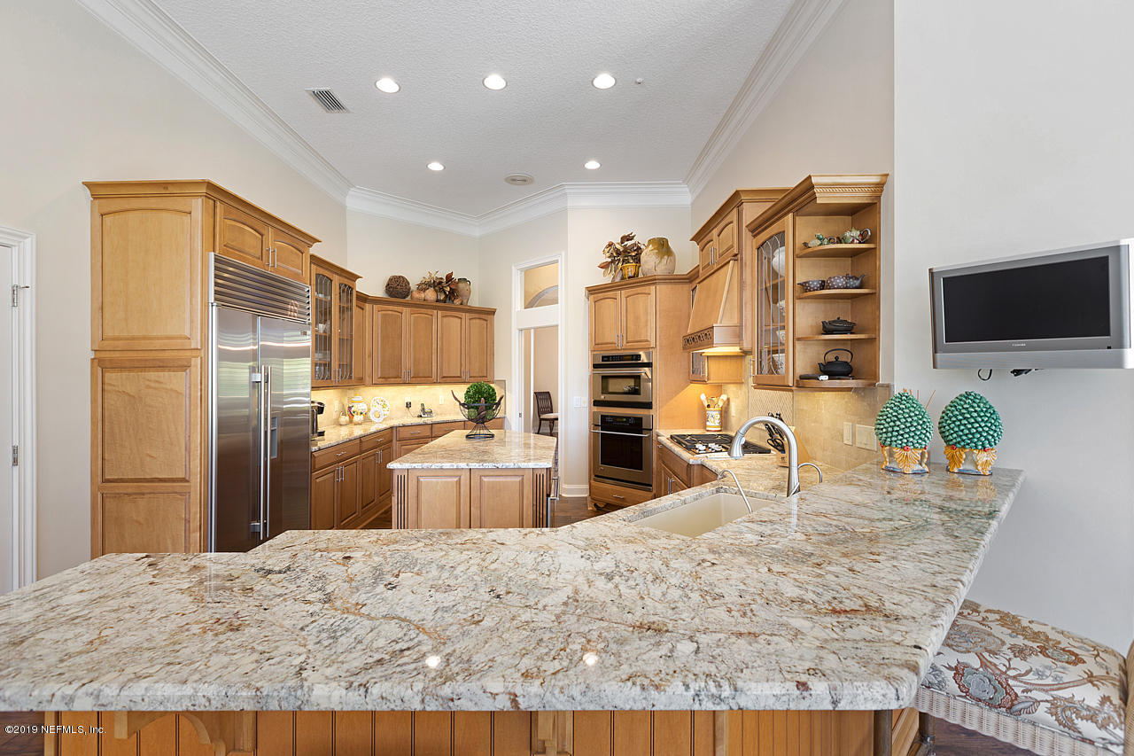 116 Governors Road Ponte Vedra Beach, FL 32082 - Photo 21 of 57 a kitchen with stainless steel appliances kitchen island granite countertop a refrigerator and a sink