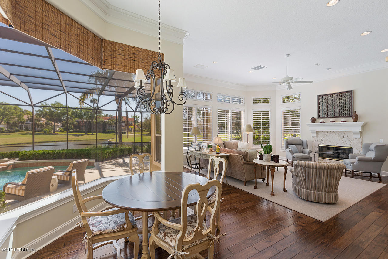 116 Governors Road Ponte Vedra Beach, FL 32082 - Photo 24 of 57 a dining room with furniture a fireplace and wooden floor