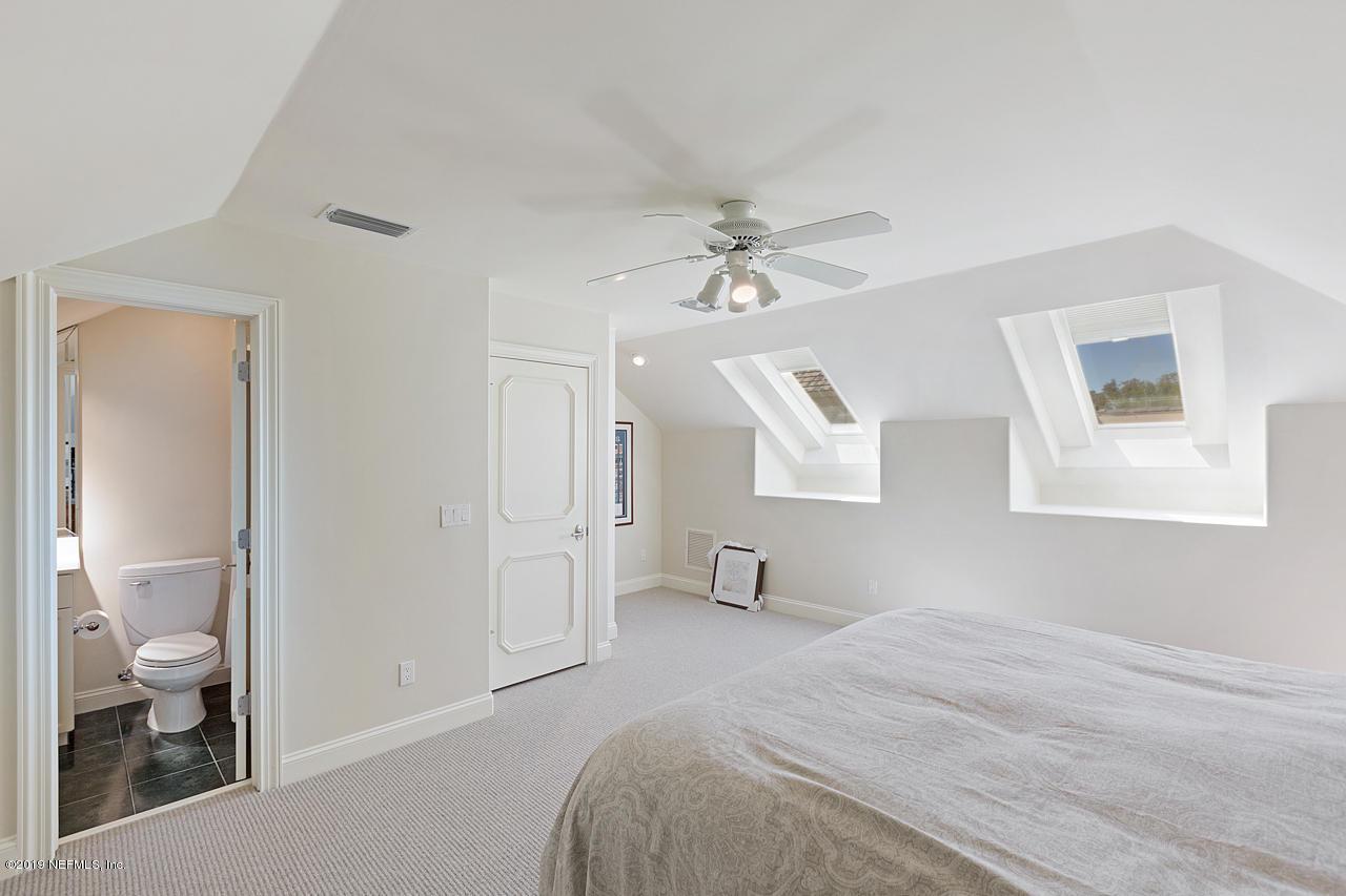 116 Governors Road Ponte Vedra Beach, FL 32082 - Photo 34 of 57 a bedroom with a bed and a chandelier