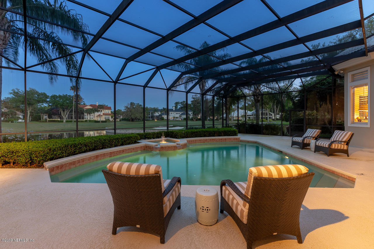 116 Governors Road Ponte Vedra Beach, FL 32082 - Photo 40 of 57 a view of a swimming pool with a couches chairs and a yard