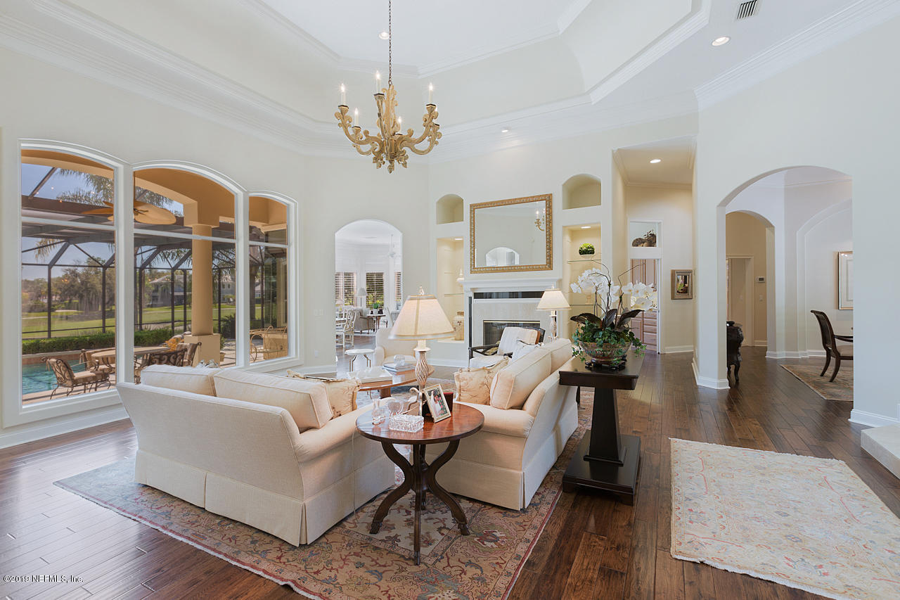 116 Governors Road Ponte Vedra Beach, FL 32082 - Photo 8 of 57 a living room with furniture chandelier and a large window