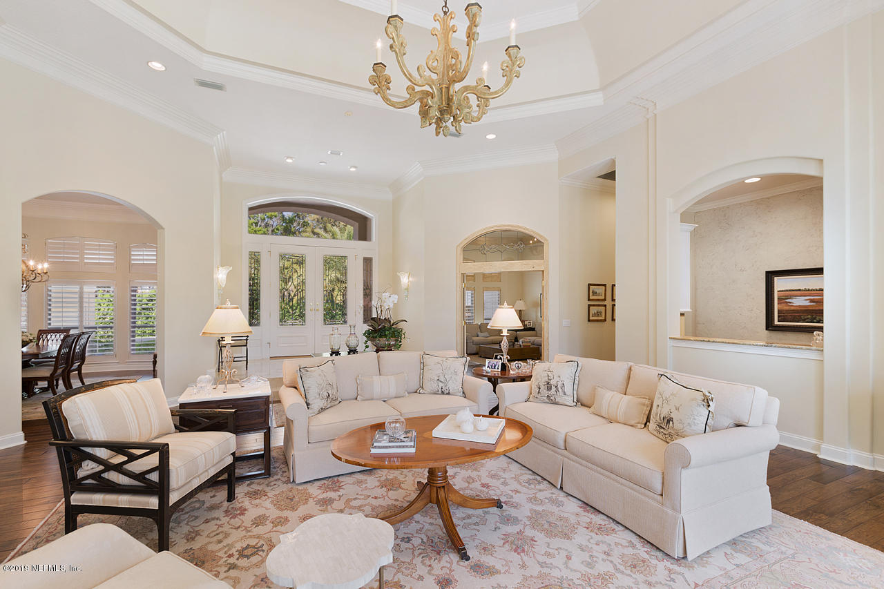 116 Governors Road Ponte Vedra Beach, FL 32082 - Photo 9 of 57 a living room with furniture a large window and a chandelier