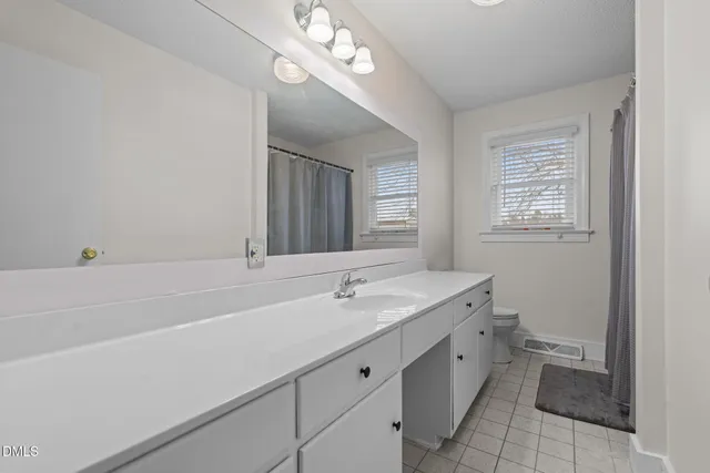 a bedroom with a bed and a chair