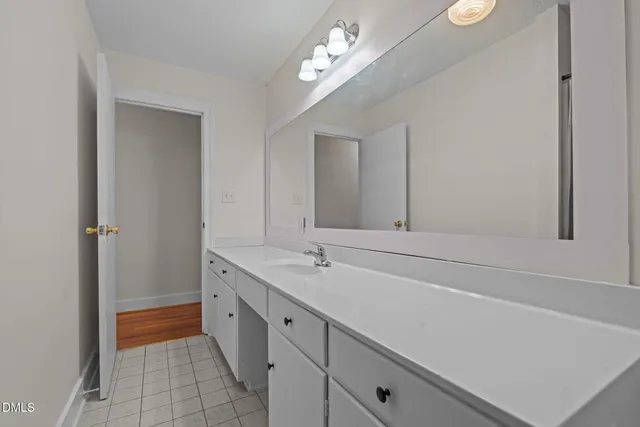 a spacious bathroom with a granite countertop sink a toilet and a bathtub