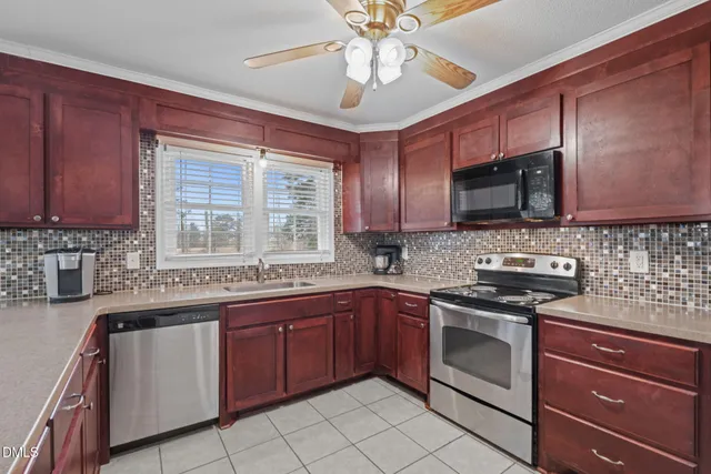 a kitchen with stainless steel appliances granite countertop stove top oven a sink dishwasher and a microwave oven on the blue kitchen countertops