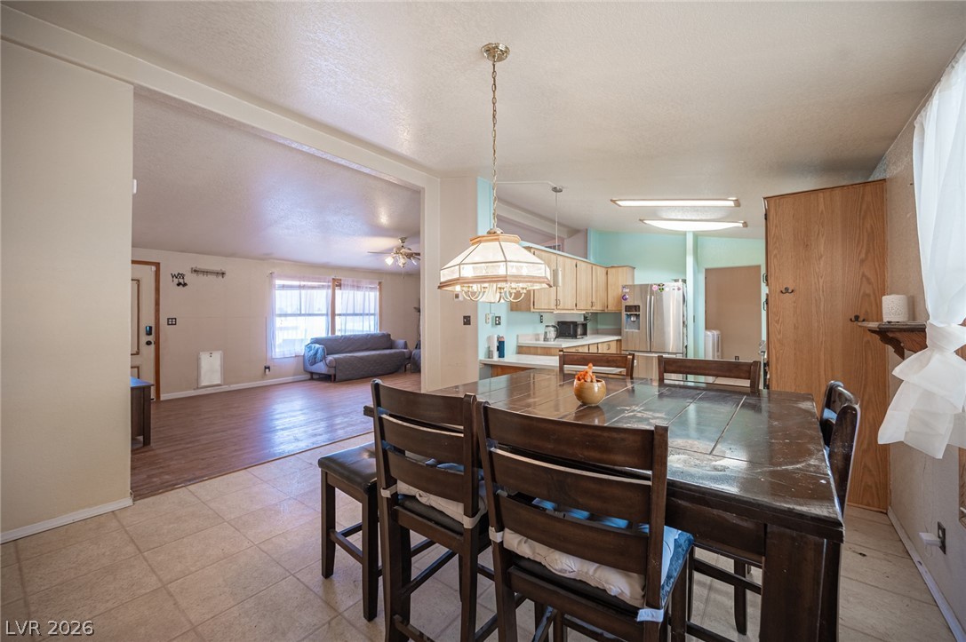 3200 Maple Road Pahrump, NV 89048 - Photo 14 of 53 An inviting open-concept layout connects the dining area, kitchen, and living room.
