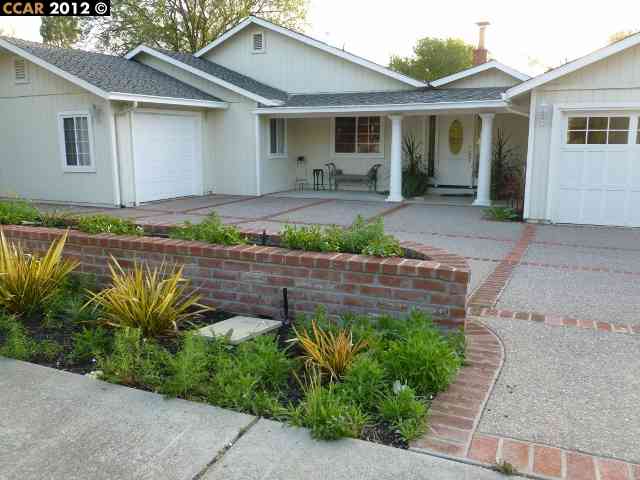a front view of a house with garden