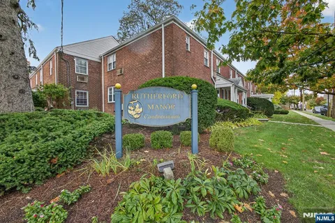 a brick house with a yard and plants
