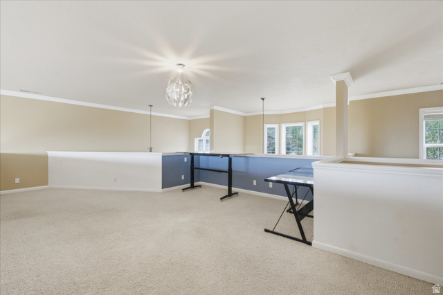 2887 View Crest Circle North Logan, UT 84341 - Photo 17 of 37 Empty room featuring light carpet and ornamental molding