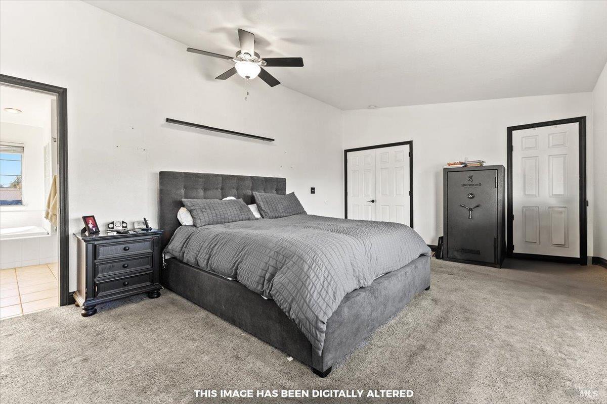 4457 Graywhaler Lane Rohnert Park, CA 94928 - Photo 18 of 51 a spacious bedroom with a bed and a ceiling fan