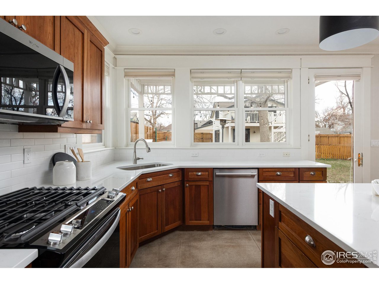 721 Concord Avenue Boulder, CO 80304 - Photo 11 of 40 a kitchen with stainless steel appliances a sink stove and window