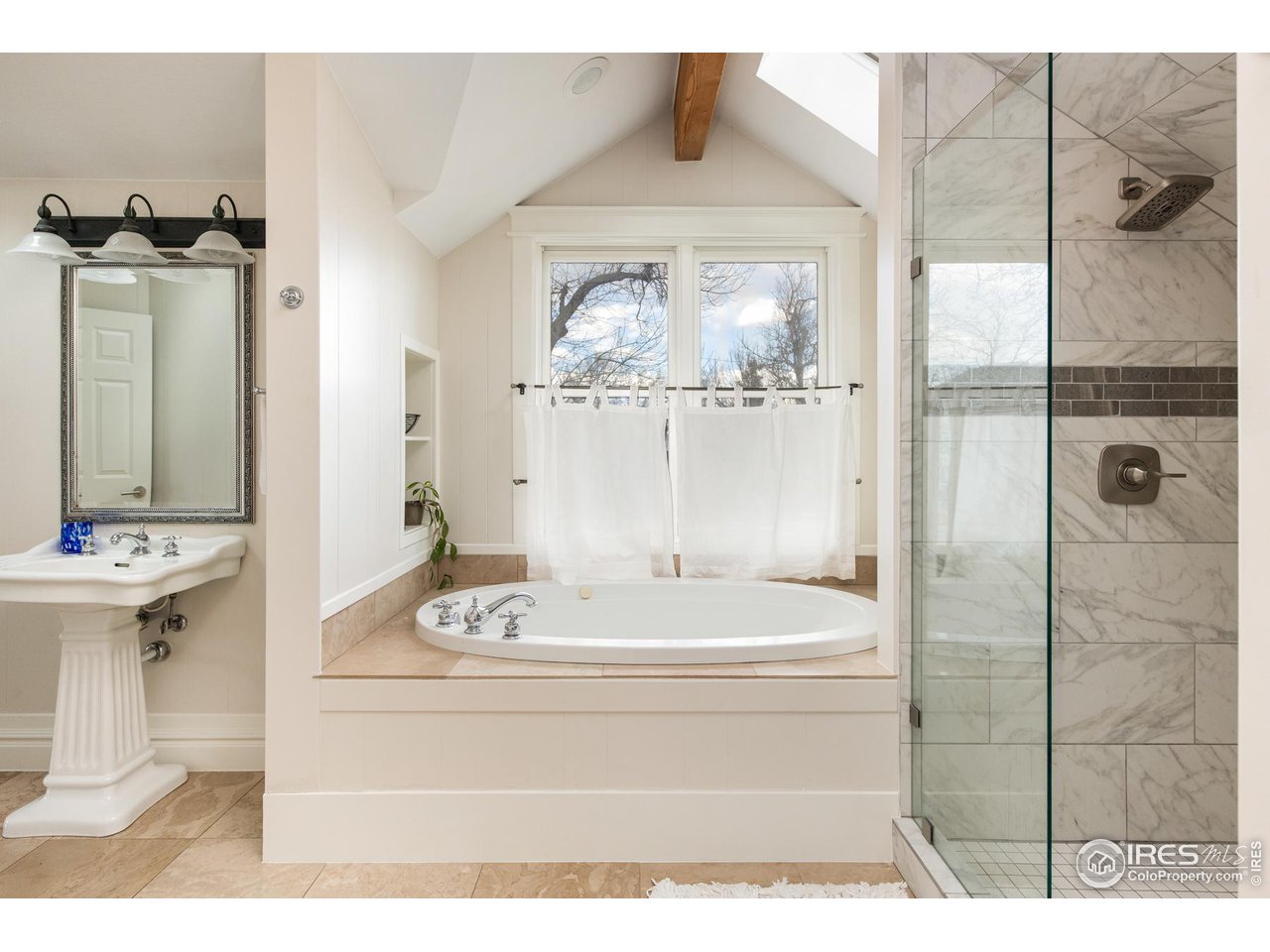 721 Concord Avenue Boulder, CO 80304 - Photo 26 of 40 a bathroom with a bathtub a sink and a mirror
